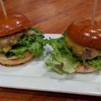Beef Sliders · Two sliders with ground NY strip, sharp cheddar cheese, lettuce, and pickles.