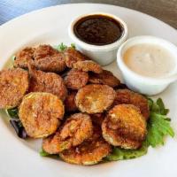 Fried Pickles · Dill pickle chips battered, deep-fried, and served with two sauces: ranch and tangy BBQ.  Ve...