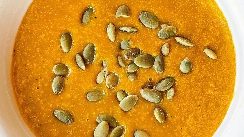Butternut Squash Soup · Roasted butternut squash blended with organic carrots & celery, onions, garlic, fresh thyme, almond milk, and a hint of curry. Topped with toasted pumpkin seeds.  Vegan, vegetarian, and gluten free. Contains nuts.