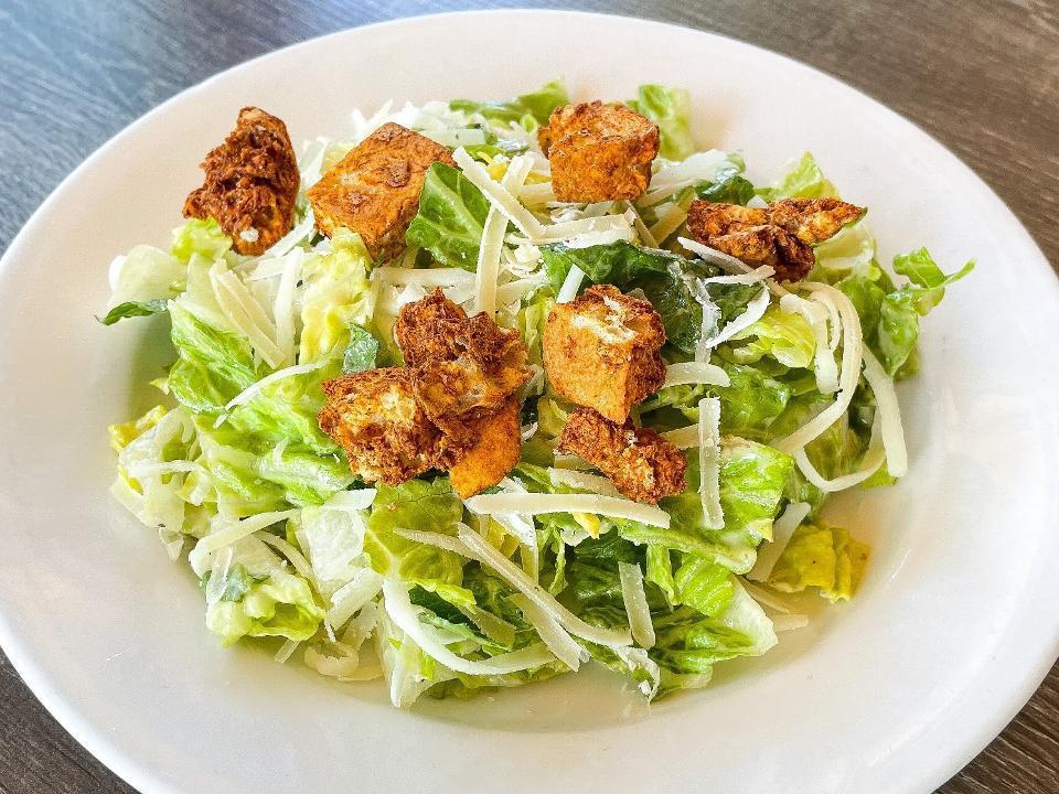 Caesar Salad · Chopped romaine cut and tossed with garlic-herb croutons and Parmesan cheese. Vegetarian, can be vegan, can be gluten free.