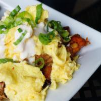 Pulled Pork Hash · Spiced potatoes topped with pulled pork, scrambled eggs, crema and green onions.