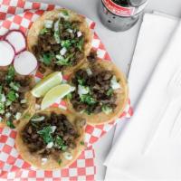 Tacos · onions and cilantro