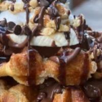 Banana-Nut Waffles · 2 Belgian Waffles layered with Nutella, topped with fresh banana's, crushed walnuts, mini-ch...