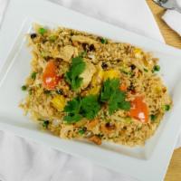 Pineapple Fried Rice · With pineapple, cashew nuts, raisins, tomatoes, onions, scallions, green peas and egg.