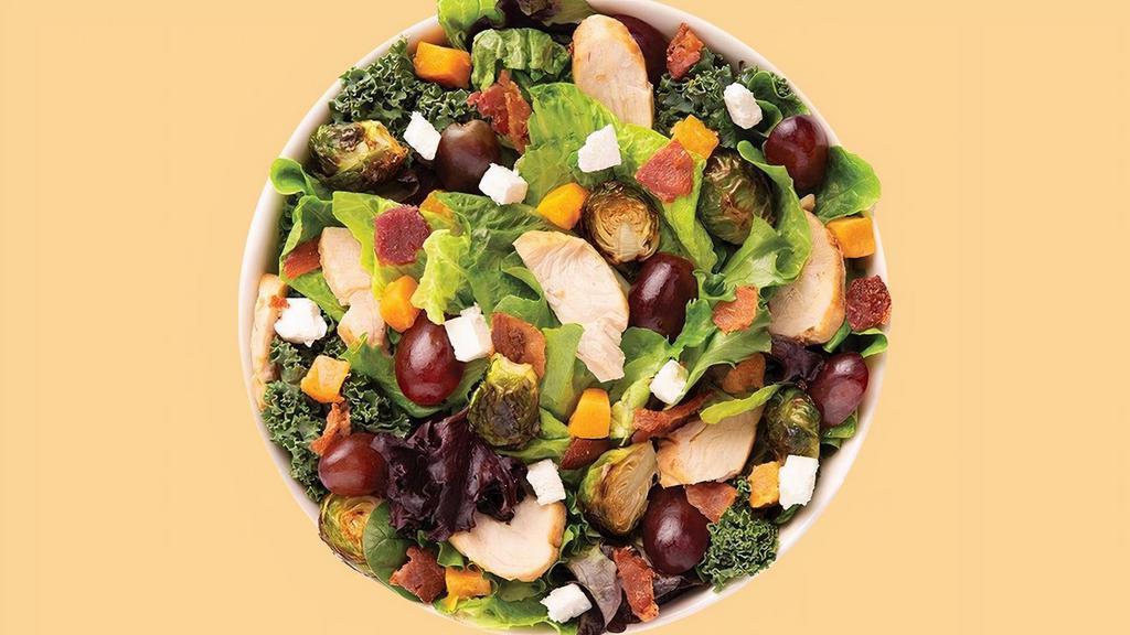 Farmers Market Salad · Our Chef-inspired Farmers Market features a recommended base of our Super Greens Blend. It is served with Roasted Turkey, Roasted Butternut Squash, Roasted Brussels Sprouts, Smoky Bacon, Red Grapes and Feta Cheese. We recommend our Balsamic Vinaigrette dressing.