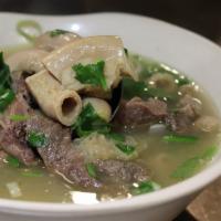 Tom Kueng Nai · An authentic Lao beef soup cooked with a variety of tripe, intestines, herbs. and topped wit...