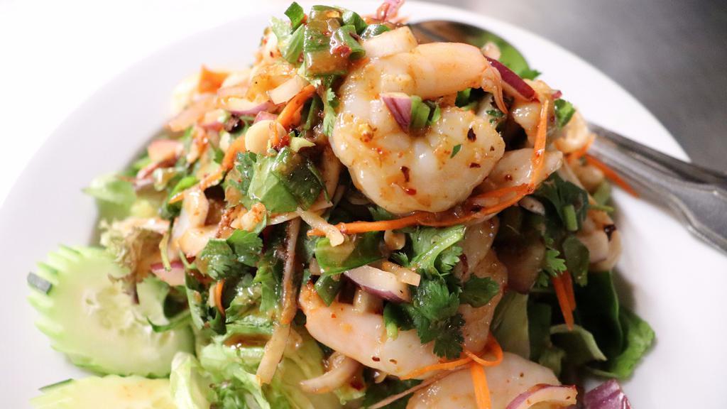 Yum Koung (Spicy Shrimp Salad) (Medium) · Shrimp tossed in house spices, red onions, green onions, cilantro, jalapeños, and lime juice. Served on a bed of lettuce.
