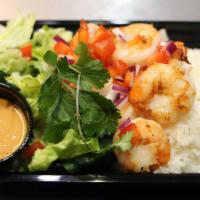 Sautéed Shrimp Bowl · Sautéed Shrimp over steamed rice, topped with leafy green lettuce, chopped purple onions, be...