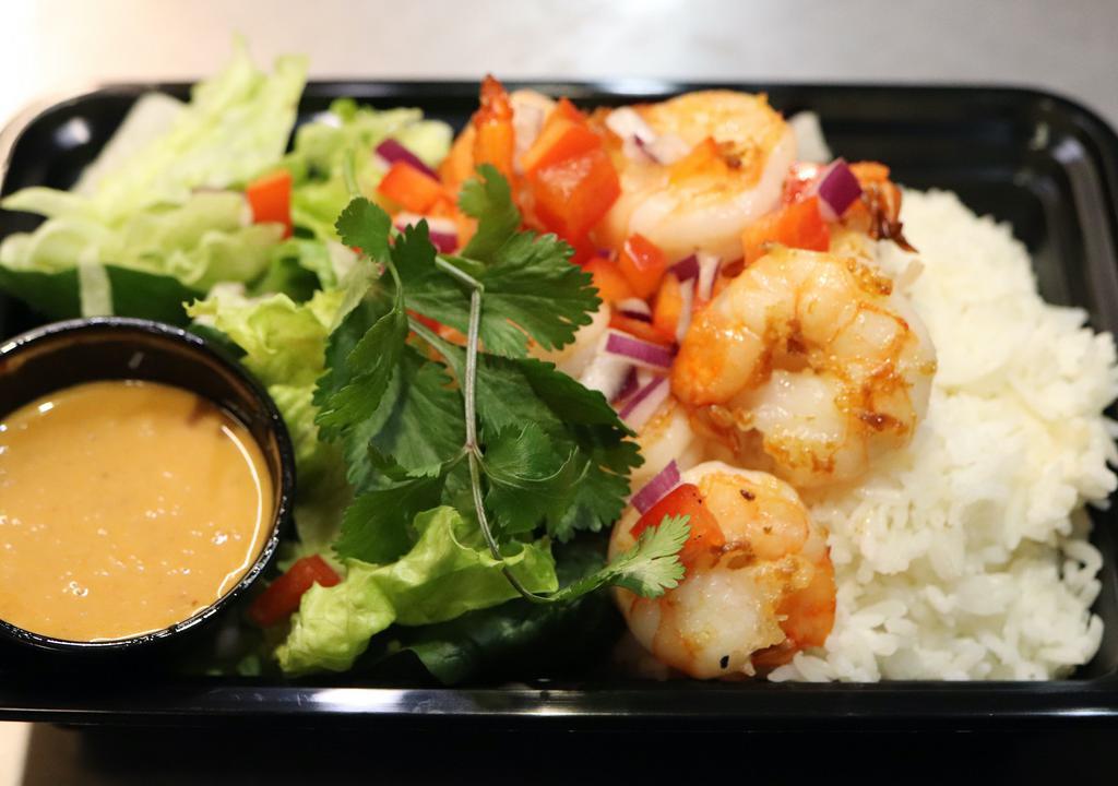 Sautéed Shrimp Bowl · Sautéed Shrimp over steamed rice, topped with leafy green lettuce, chopped purple onions, bell peppers, cilantro, and served with your choice of our Creamy Yum Nua dressing or Sweet Chili sauce on the side.