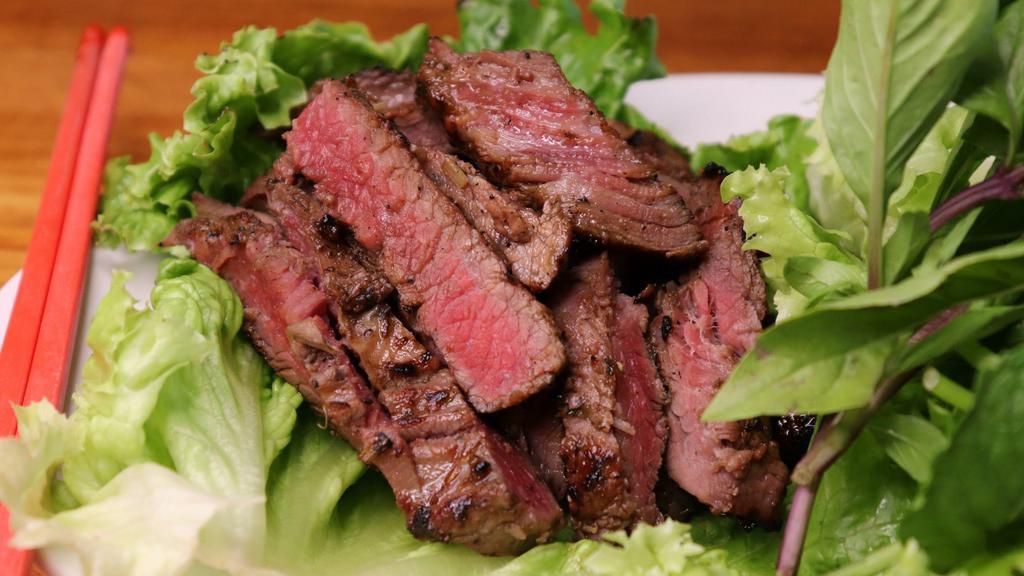 Namtoke · Sliced grilled steak marinated in our house seasoning served with lettuce, cilantro and spicy lemon dipping sauce.