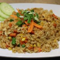 Fried Rice · Stir fried rice with eggs, peas, carrots, and com.