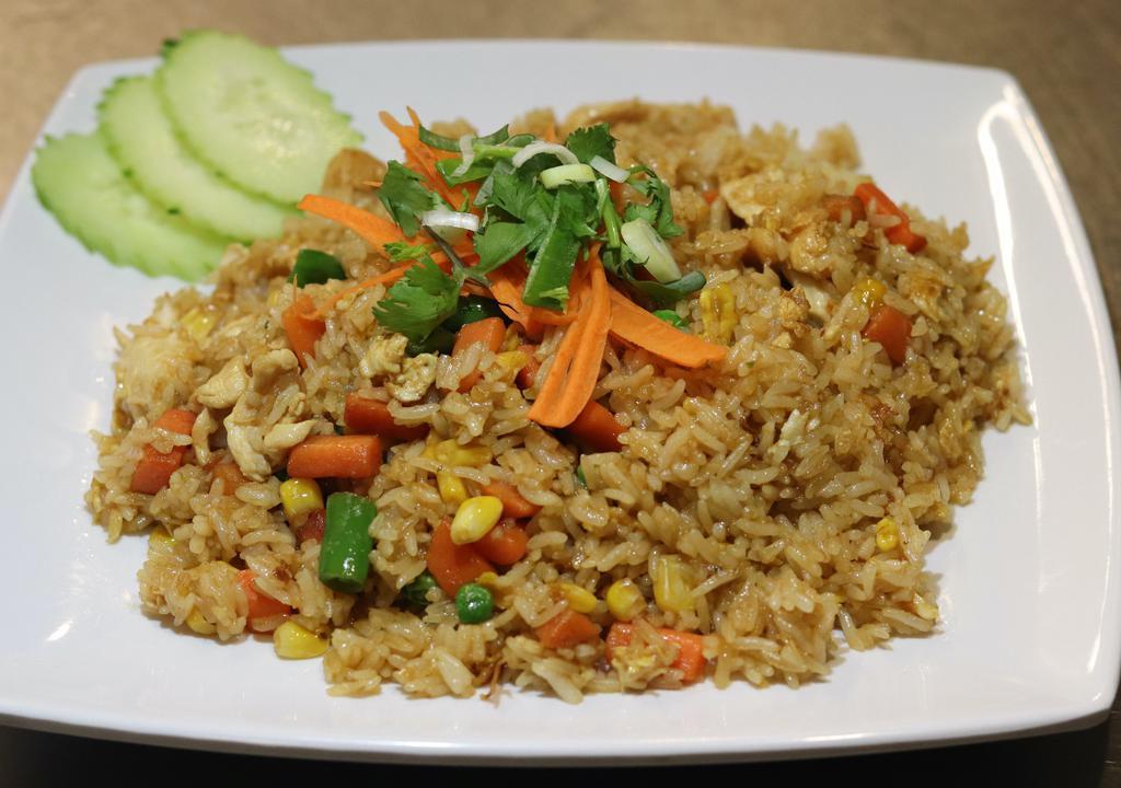 Fried Rice · Stir fried rice with eggs, peas, carrots, and com.
