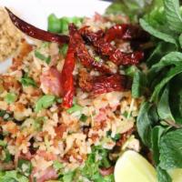 Nam Khao · Marinated crispy rice tossed with coconut, preserved pork sausage, peanuts, lime juice and f...
