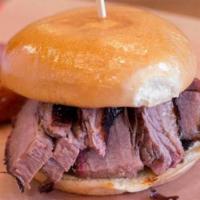 Brisket · BBQ Sandwich with Sliced Brisket, pickles, onions, and choice of one side.