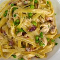 Chicken Carbonara · Sauté of grilled chicken, smoked bacon, green peas, Romano cheese, and cream, tossed with fe...