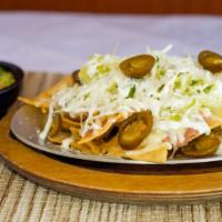 Super Nachos · Crispy homemade corn tortilla chips with melted cheese, refried beans. Guacamole, sour cream...