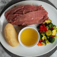 Corned Beef & Cabbage · Corned beef over cabbage served with au jus, boiled potato and roasted vegetables. Please co...