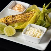 Grilled Corn On The Cob · Served with chili mayo, cotija cheese & lime.