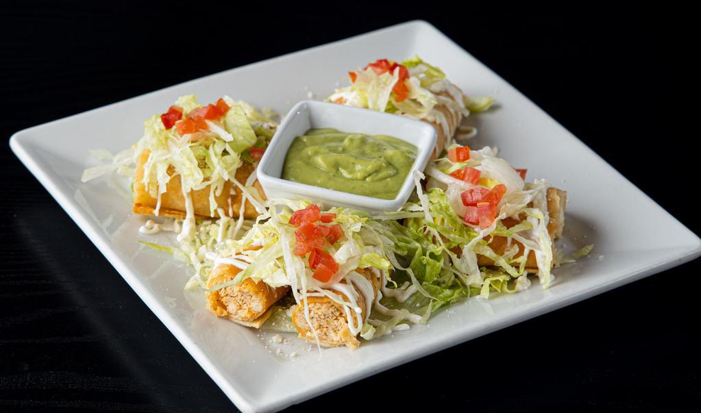 Crispy Taquitos · Four crispy taquitos (chicken & potato) topped with lettuce, sour cream, cotija cheese, and chopped tomatoes. Served with avocado salsa.
