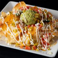 Nachos Tulum · Topped with pico de gallo, guacamole, cheese, jalapeños and sour cream.