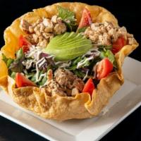 Tostada Chicken Salad · Tostada bowl filled with spring mix, grilled chicken, tomato, avocado, rice, refried beans, ...