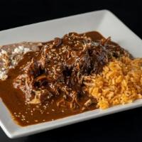 Mole Poblano · Shredded chicken covered in mole  poblano.  Served with rice, beans, and handmade soft corn ...