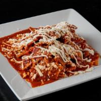 Chilaquiles · Crispy corn tortillas in a green, red or mole sauce.  Topped with sour cream and cheese.