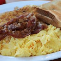 Deluxe Breakfast · Three farm fresh eggs any style, four strips of bacon, crispy hashbrowns and buttered toast