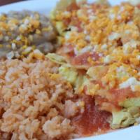 Chilaquiles · Three farm fresh eggs scrambled and pan-fried with corn tortilla chips and topped with our h...