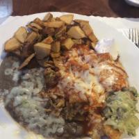 Chilaquiles · Comes with choice of refried or black beans and potatoes.