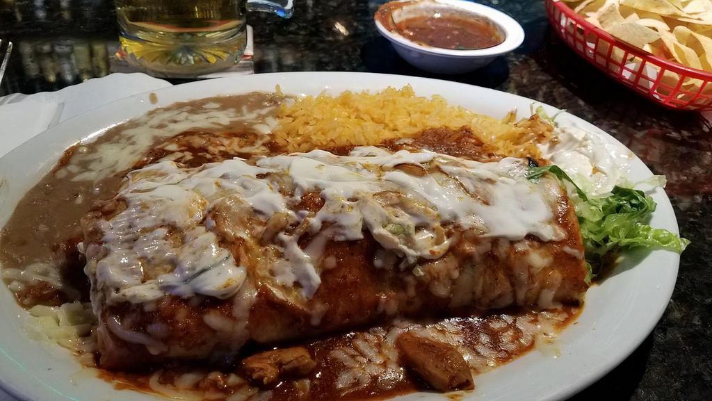 Chicken Diabla Burrito · Filled with grilled chicken, salsa diabla, grilled onions, beans, cheese, topped with salsa diabla. Comes with rice and choice of refried or black beans.