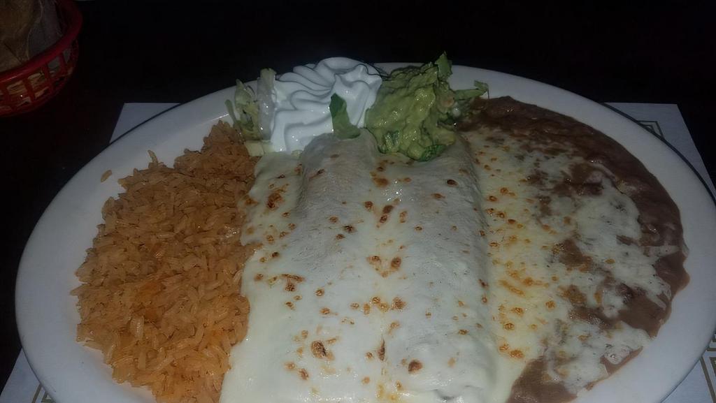 Sour Cream Enchiladas · Two chicken enchiladas with sour cream sauce. Comes with rice and choice of refried or black beans.
