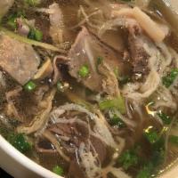 Pho Dac Biet · Combo noodle soup with rare beef, tendon, brisket, flank, tripe, and meatball topped with ci...