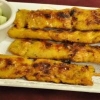 Satay · Skewers of seasoned choice of chicken or beef or pork or served with a peanut sauce and cucu...
