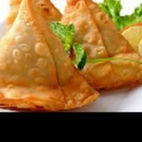 Vegetable Samosa · Vegan. Two samosas filled with mildly spiced potatoes and peas deep fried served with sweet ...