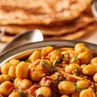 Chana Masala · Vegan. Garbanzo beans slow-cooked in a sauce with herbs and spices.