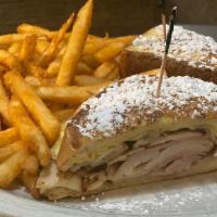Monte Cristo · Smoked ham, turkey breast, Swiss & American cheese on thick sliced egg bread battered and gr...