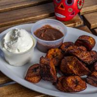 Frito Sliced Platanos · Fried with a drizzle of sour cream or coconut cream and beans.