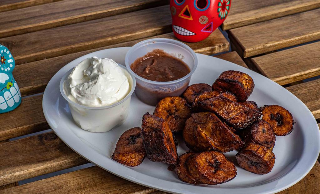 Frito Sliced Platanos · Fried with a drizzle of sour cream or coconut cream and beans.