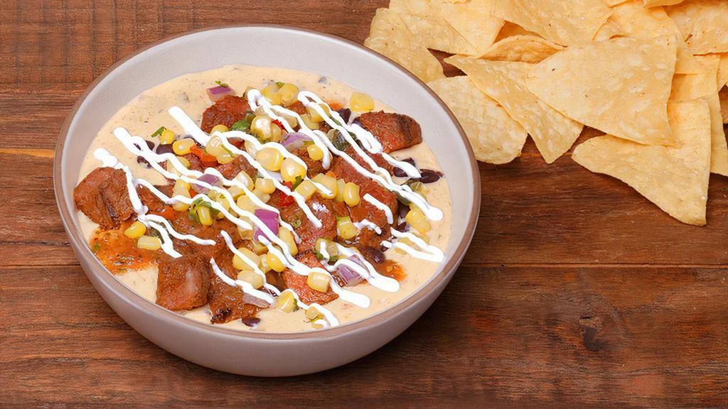 So Rich Loaded Queso · This queso packs a bold punch your taste buds won't forget! QDOBA's classic three-cheese queso topped with your choice of protein, black beans, chile corn salsa, roasted tomato salsa, and sour cream. Served with chips on the side.