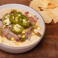 Priceless Pork Verde Loaded Queso · QDOBA's classic three-cheese queso jammed with Pulled Pork, black beans, chile corn salsa, r...