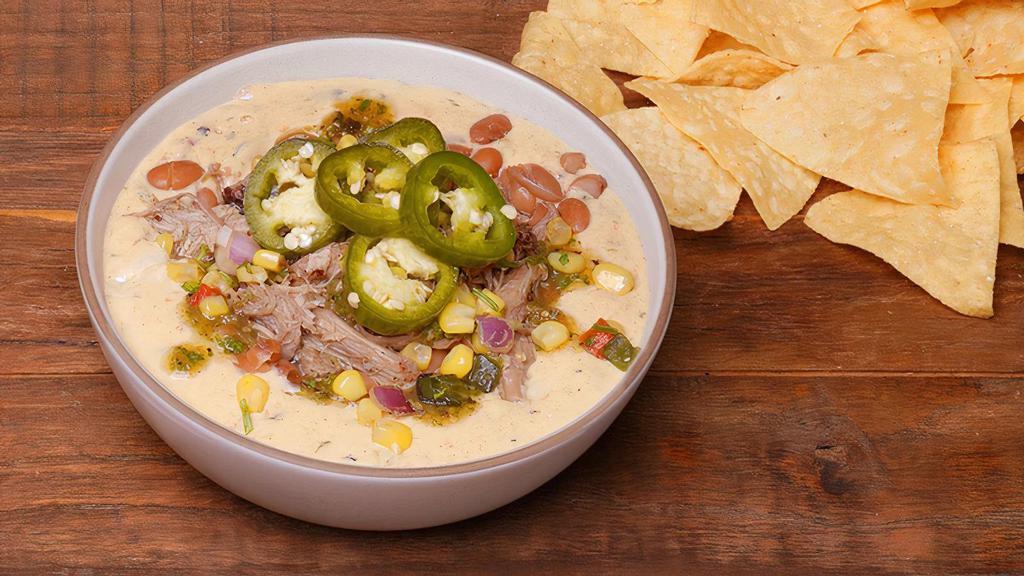 Priceless Pork Verde Loaded Queso · QDOBA's classic three-cheese queso jammed with Pulled Pork, black beans, chile corn salsa, roasted tomato salsa, and homemade pickled jalapeños for that kick of spice. Served with chips on the side. Good for a crowd, better for just you.
