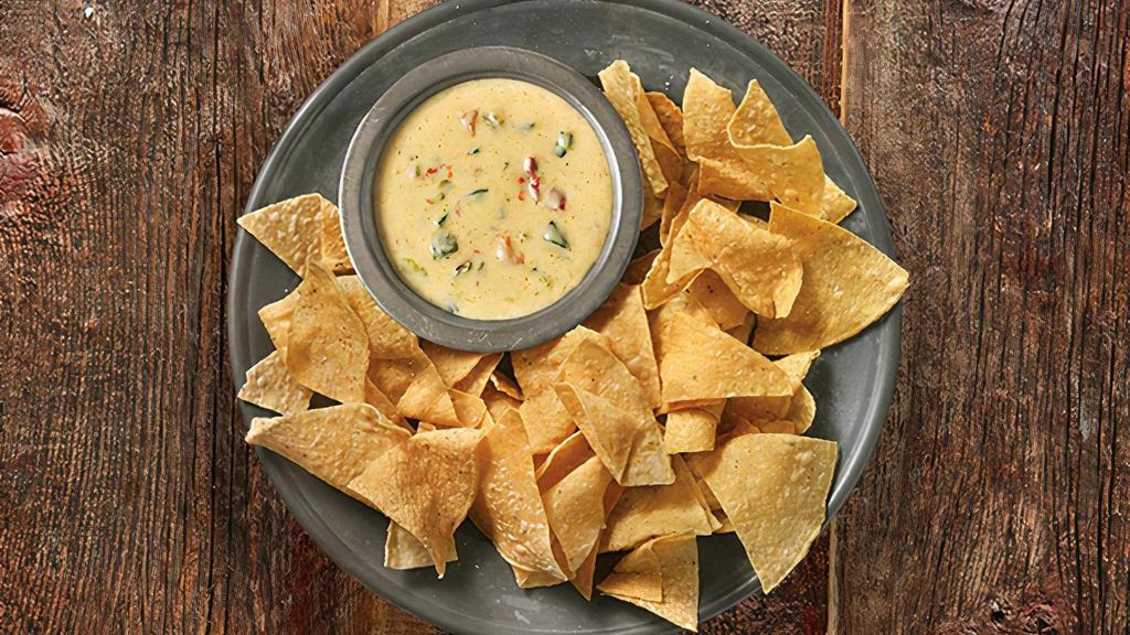 3-Cheese Queso & Chips · QDOBA's signature 3-Cheese Queso, served with freshly fried tortilla chips seasoned with salt and lime.