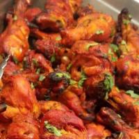 Tandoori Chicken A La Carte · Skinless marinated chicken cooked on skewers over mesquite charcoal in tandoor.
