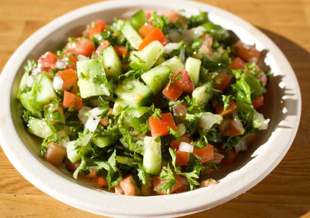 Shirazi Salad · Chopped parsley, diced tomato, cucumber, onion, lemon juice, and extra virgin olive oil.