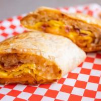 Breakfast Burrito · Filled with hash browns, two eggs and bacon, ham or sausage.