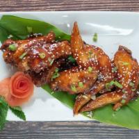 Sartori Thai Wing · House spicy sauce glazed surrounds crispy chicken wings. Top with chopped scallion.