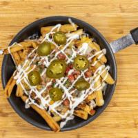 Nacho Fries · French fries topped with black or pinto beans, ground beef, jack cheese, cheddar cheese, pic...