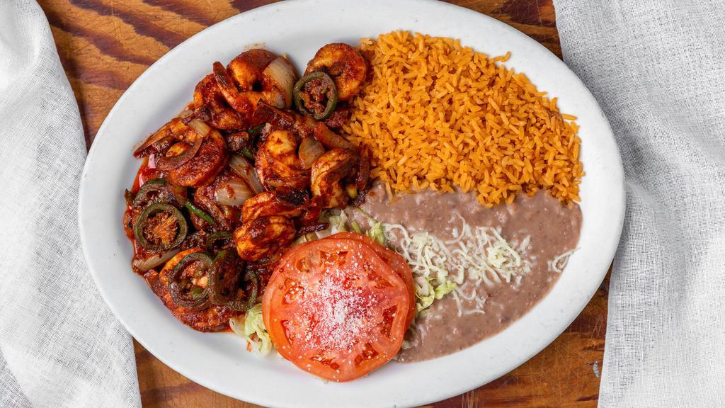 Camarones A La Diabla · Grilled shrimp, bell peppers, & onions with special chipotle sauce. Served with rice, beans, tortillas, & garnished with lettuce & tomato.