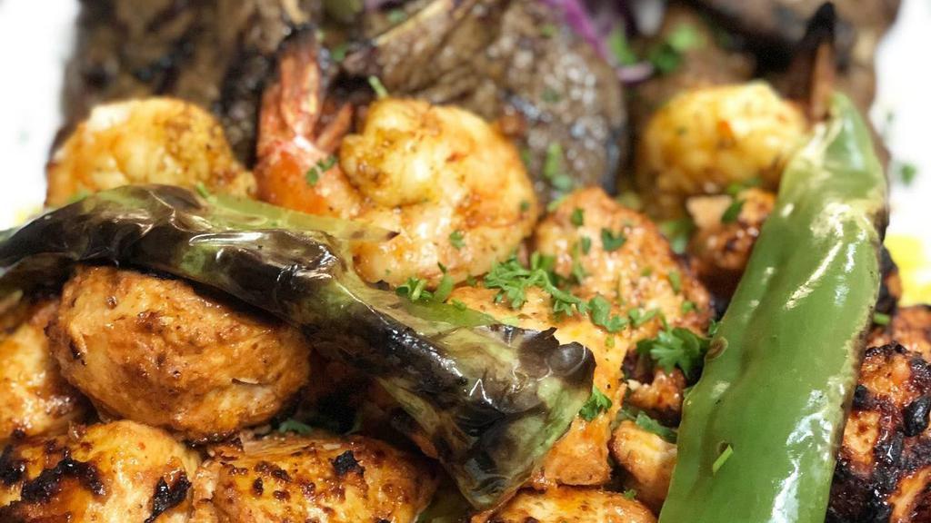 Shrimp Kabob · Grilled marinated jumbo shrimp skewered and grilled over open flames. Served with rice pilaf, grilled vegetables and a side salad.